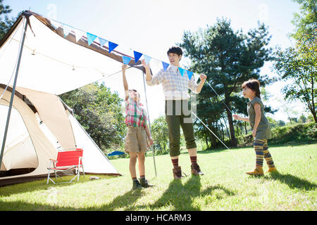 Loving father, son and daughter having camping Stock Photo