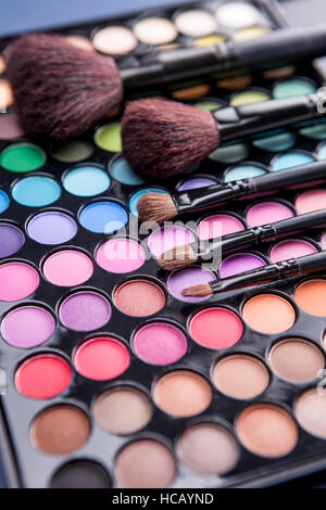 Cosmetic brushes on shadow palette Stock Photo