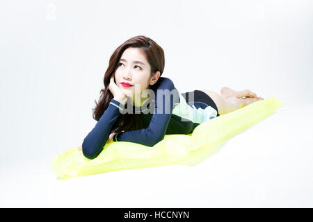 Nude woman lying face down on bed Stock Photo - Alamy