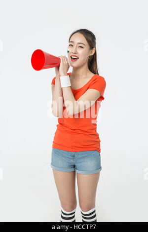 Young smiling woman holding megaphone Stock Photo