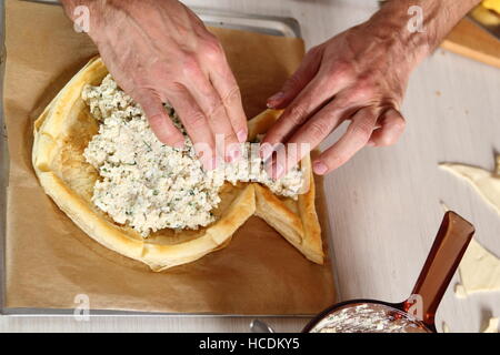 Place filling on prepared pastry. Making Salmon in Puff Pastry Series. Stock Photo