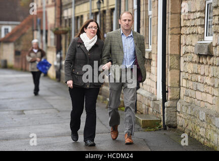 Conservative candidate Dr Caroline Johnson (left) and her husband Nik arrive to cast their vote at Ancaster Parish Hall, Lincolnshire. Stock Photo