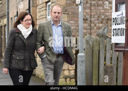 Conservative candidate Dr Caroline Johnson (left) and her husband Nik arrive to cast their vote at Ancaster Parish Hall, Lincolnshire. Stock Photo