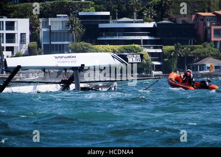 Sydney, Australia. 08th Dec, 2016. Visit Madeira (POR), skippered by Diogo Cayolla (POR) capsizes in race three of the first day of Act 8 of the Extreme Sailing Series in Sydney Harbour. Credit:  Hugh Peterswald/Pacific Press/Alamy Live News Stock Photo