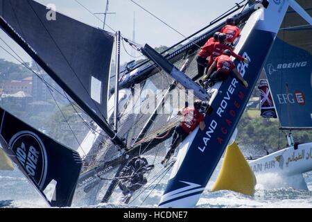Sydney, Australia. 08th Dec, 2016. Land Rover BAR Academy (GBR), skippered by Neil Hunter (GBR) sailors scramble to hold on as the vessel capsizes on the waters of the Sydney Harbour in Australia. Credit:  Hugh Peterswald/Pacific Press/Alamy Live News Stock Photo