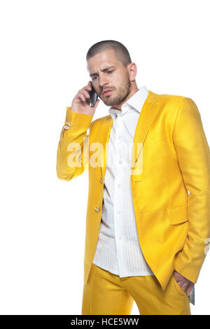 business man in gold suit talks on the phone Stock Photo