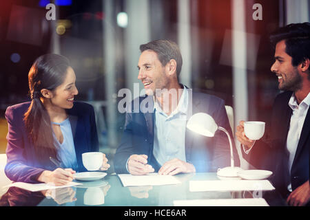 Group of businesspeople interacting with each other Stock Photo