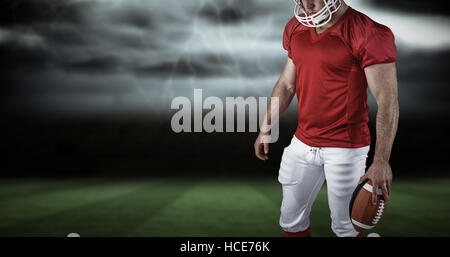 Composite image of american football player with ball Stock Photo