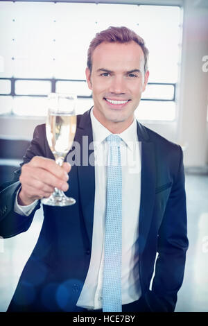 Portrait of businessman holding champagne flute Stock Photo