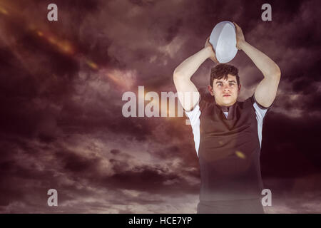 Composite image of portrait of a rugby player throwing a ball Stock Photo