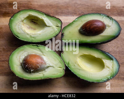 Two delicious ripe avocados cut into halves Stock Photo