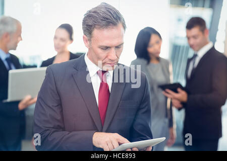 Mature businessman using digital tablet Stock Photo