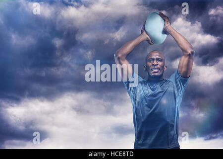 Composite image of determined sportsman throwing rugby ball 3D Stock Photo