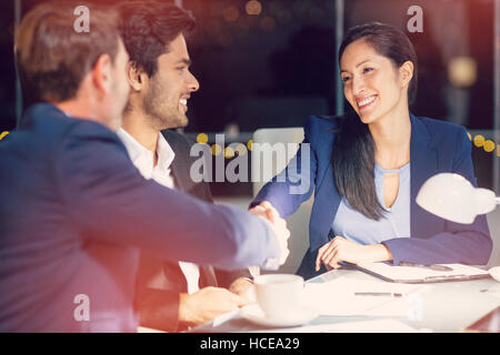 Businessman shaking hands with colleague Stock Photo