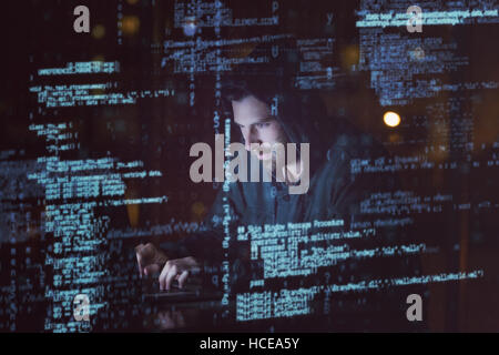 Hacker using laptop Stock Photo