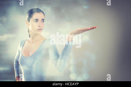 Composite image of young woman gesturing against white background Stock Photo