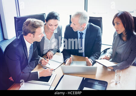 High angle view of businesspeople interacting in conference room Stock Photo