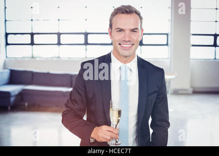Portrait of businessman holding champagne flute Stock Photo