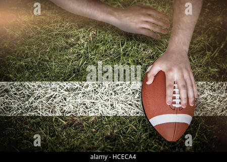 Composite image of american football player scoring a touchdown Stock Photo