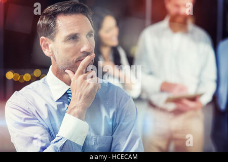 Thoughtful businessman in office Stock Photo