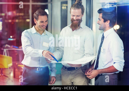 Businessmen discussing over blueprint Stock Photo