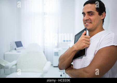 Smiling doctor holding a digital tablet at clinic Stock Photo
