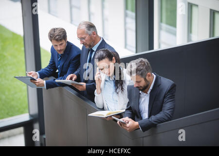 Businesspeople using mobile phone and digital tablet Stock Photo