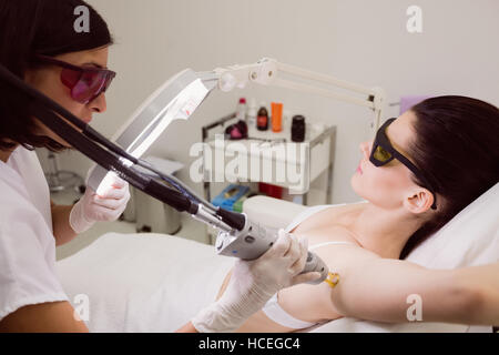 Female patient receiving laser hair removal treatment Stock Photo