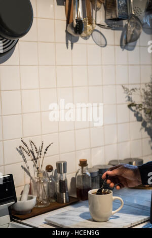 Man preparing a black coffee in kitchen Stock Photo
