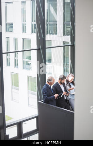 Businesspeople using mobile phone and digital tablet Stock Photo