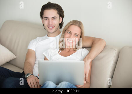 Young happy couple in living room Stock Photo