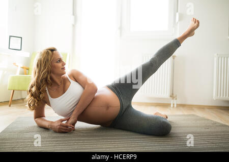 Pregnant woman staying active and healthy at home Stock Photo