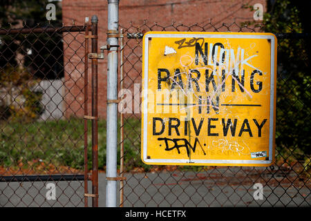 No parking sign on a chain link fence Stock Photo