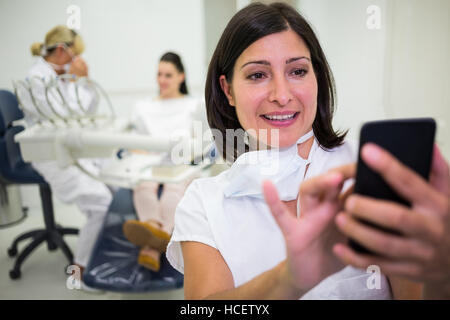 Female doctor using mobile phone Stock Photo