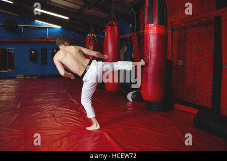 Karate player practicing kickboxing Stock Photo
