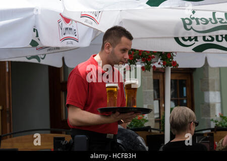A waiter serving Polish beers in Krakow,Poland Stock Photo