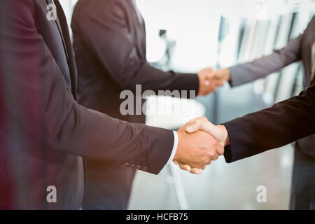 Businesspeople shaking hands with each other Stock Photo