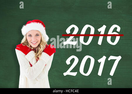 Composite image of happy festive blonde Stock Photo