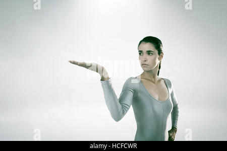 Composite image of young woman gesturing against white background Stock Photo