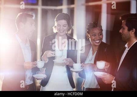 Group of businesspeople having coffee during break Stock Photo