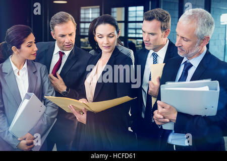 Lawyer looking at documents and interacting with businesspeople Stock Photo