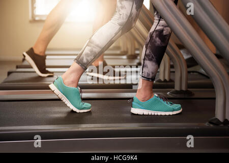 Couple jogging on the treadmill Stock Photo