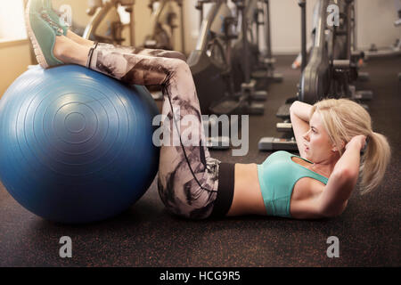 Doing sit ups on fitness ball Stock Photo