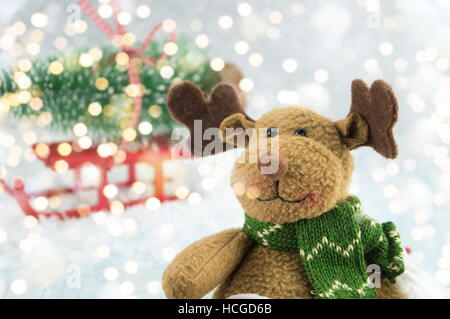 toy reindeer and a christmas tree on sleds covered with snow Stock Photo