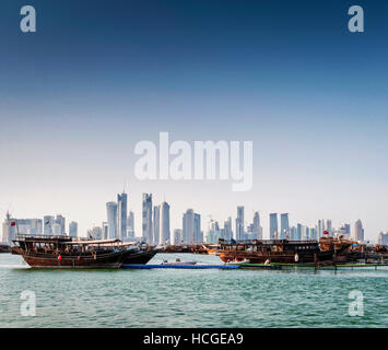 doha city skyscrapers urban skyline view and dhow boat in qatar Stock Photo