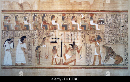 Weighing of souls. Anubis weighs the heart of Apis under the watchful eye of Toth. Papyrus of the Book of the Dead Stock Photo