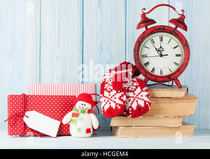 Christmas alarm clock, gift boxes and mittens. View with copy space Stock Photo