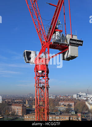 Red tower crane in operation on the redevelopment of  the BBC Television Centre site in West London. Crane sign shows the logo. Stock Photo