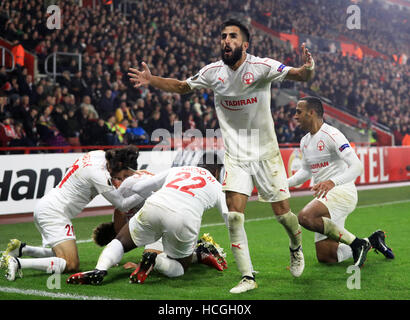 Hapoel Be'er Sheva's Maor Bar Buzaglo (hidden) celebrates scoring his side's first goal of the game with team-mates during the UEFA Europa League, Group K match at St Mary's Stadium, Southampton. Stock Photo