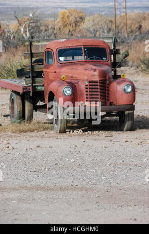 An old abandoned red truck on an empty lot in New Mexico, NM, USA. Stock Photo